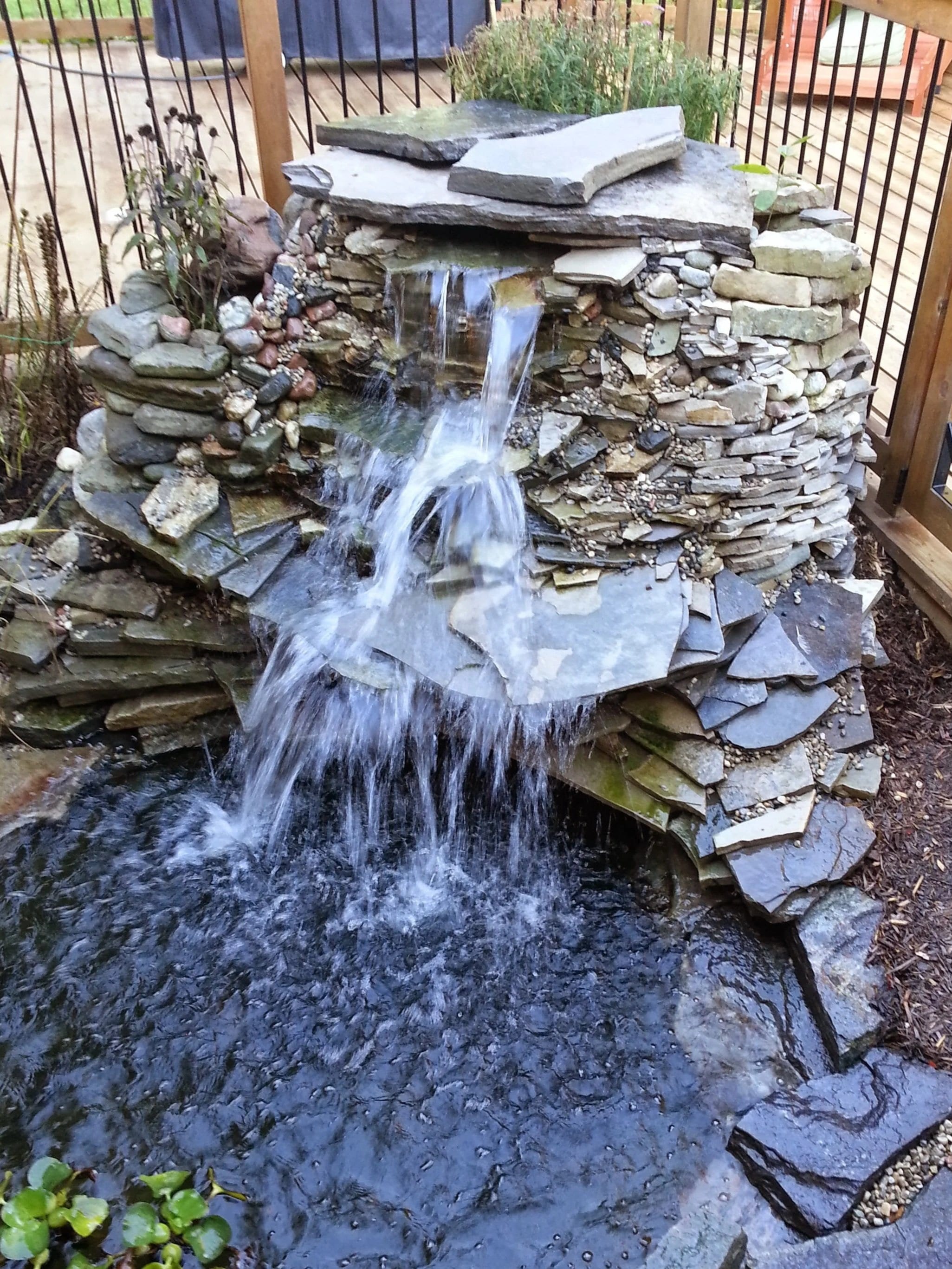 A flagstone pond and waterfall built just outside a kitchen door